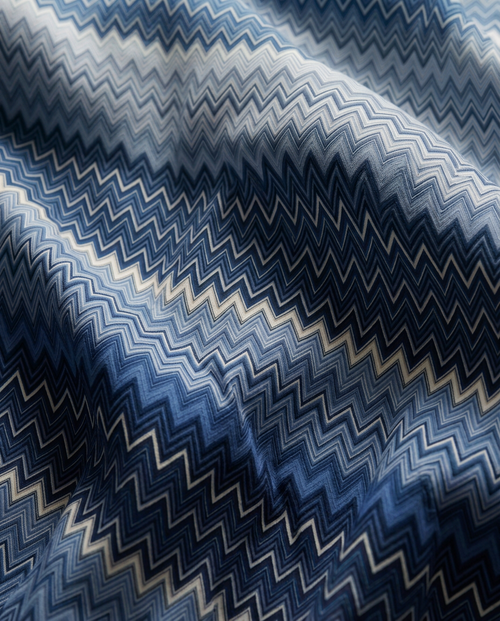 Amalfi Blue chevron print in motion — flowing fabric close-up in navy and cobalt blues