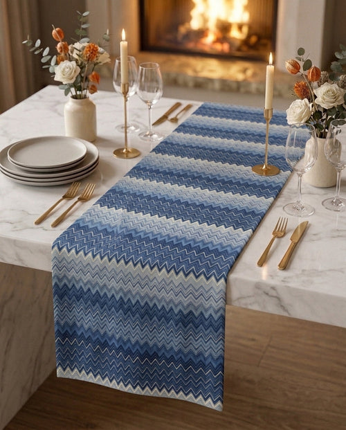Amalfi gift box — table runner and matching napkin scrunchies on a white marble dining table, candlelit setting