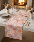 Coral Breeze gift box — table runner and matching napkin scrunchies on a white marble dining table, candlelit setting