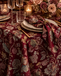 Festive Manor Burgundy tablecloth styled with gold-rimmed plates, roses and candles