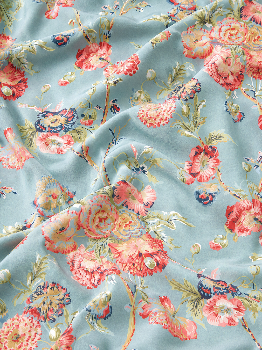 Hanami Blue tablecloth fabric close-up showing floral pattern on duck-egg blue background