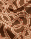 Marea Camel Brown print in motion — flowing fabric close-up of interlocking ribbon bands on camel brown