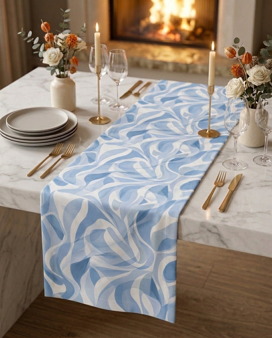 Riviera gift box — table runner and matching napkin scrunchies on a white marble dining table, candlelit setting