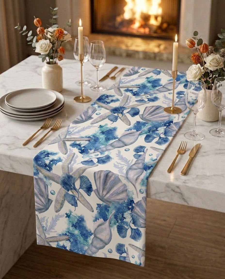 Seashell Drift gift box — table runner and matching napkin scrunchies on a white marble dining table, candlelit setting